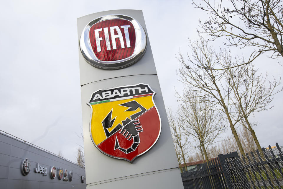 Logos of car companies are seen on the facade of the building housing the Stellantis headquarters in Lijnden, near Amsterdam, Netherlands, Monday, Jan. 18, 2021. Stellantis, the car company combining PSA Peugeot and Fiat Chrysler, was launched Monday on the Milan and Paris stock exchanges, giving life to the fourth-largest car company in the world. (AP Photo/Peter Dejong)