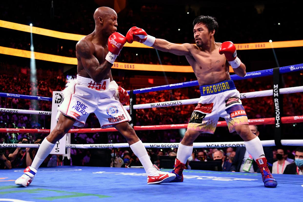 Manny Pacquiao (R) of the Philippines fights against Yordenis Ugas of Cuba during the WBA Welterweight Championship boxing match at T-Mobile Arena in Las Vegas, Nevada on August 21, 2021. (Photo by Patrick T. FALLON / AFP) (Photo by PATRICK T. FALLON/AFP via Getty Images)