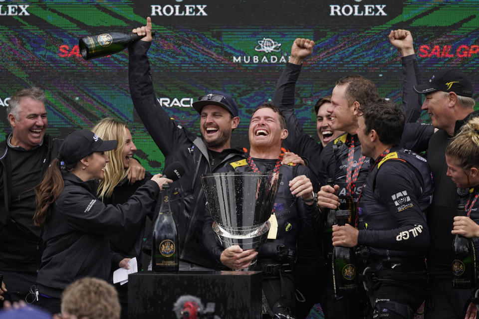 The Australia SailGP team celebrates after winning the $1 million, winner-take-all Season 2 finale of the Mubadala United States Sail Grand Prix, Sunday, March 27, 2022, in San Francisco. CEO and driver Tom Slingsby holds the trophy. (AP Photo/Eric Risberg)