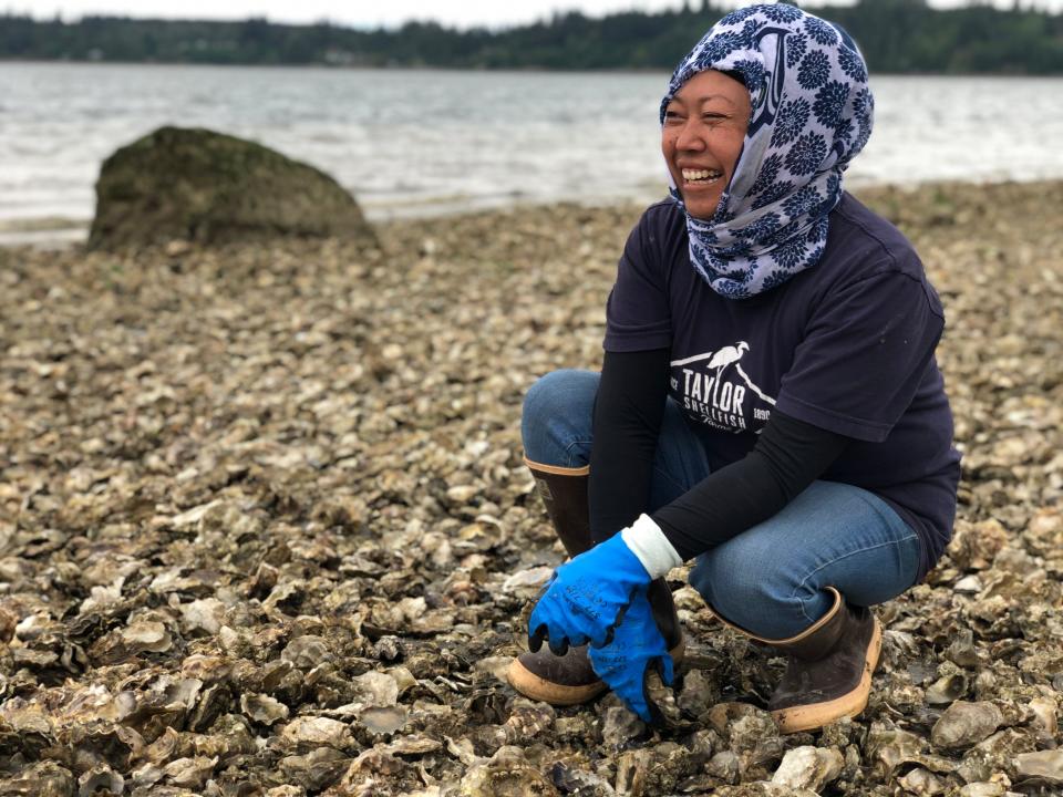 Aisha Prohim, looks for oysters on the eastern shore of the Totten Inlet near Olympia, Wash., on May 11, 2020. 