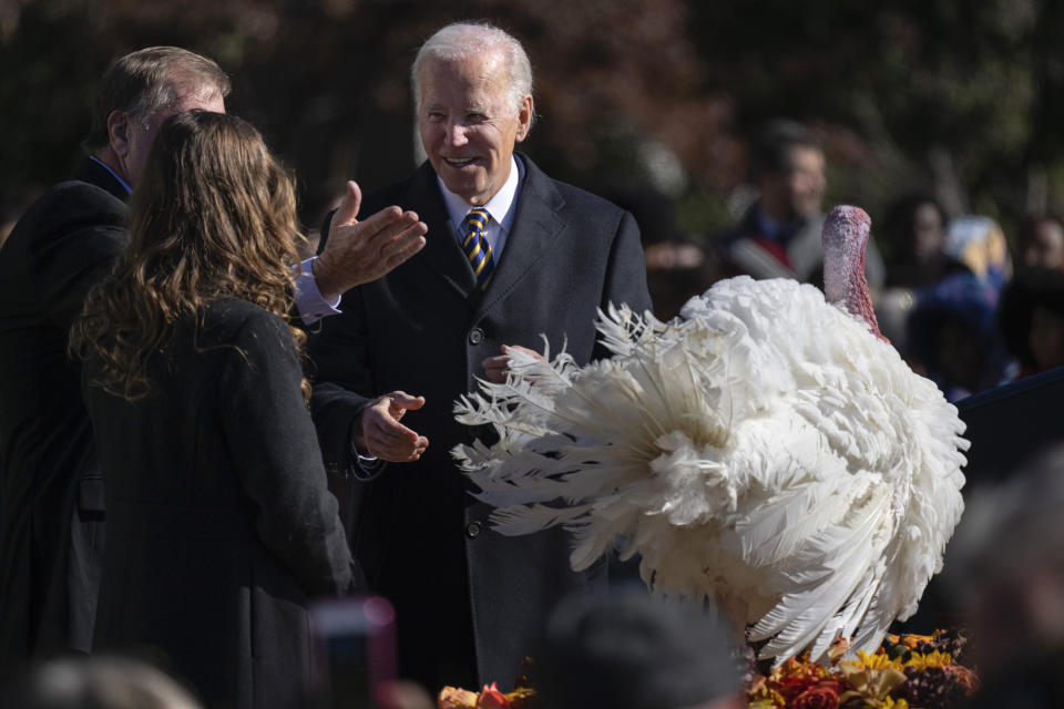 President Joe Biden pardons Chocolate, the national Thanksgiving turkey, at the White House in Washington, Monday, Nov. 21, 2022. On stage with the president are Ronald Parker, Chairman of the National Turkey Federation, and Alexa Starnes, daughter of the owner of Circle S Ranch. (AP Photo/Carolyn Kaster)