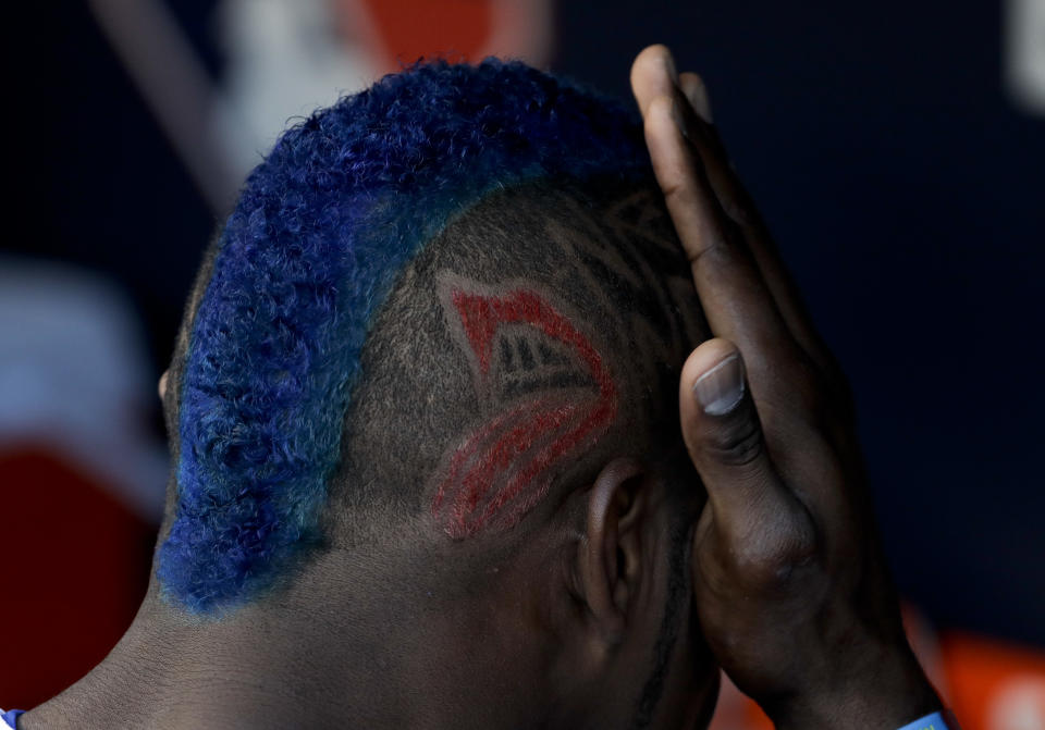 Yasiel Puig wipes his face in the dugout before Game 1 of the World Series vs. the Houston Astros. (AP Photo/Matt Slocum)