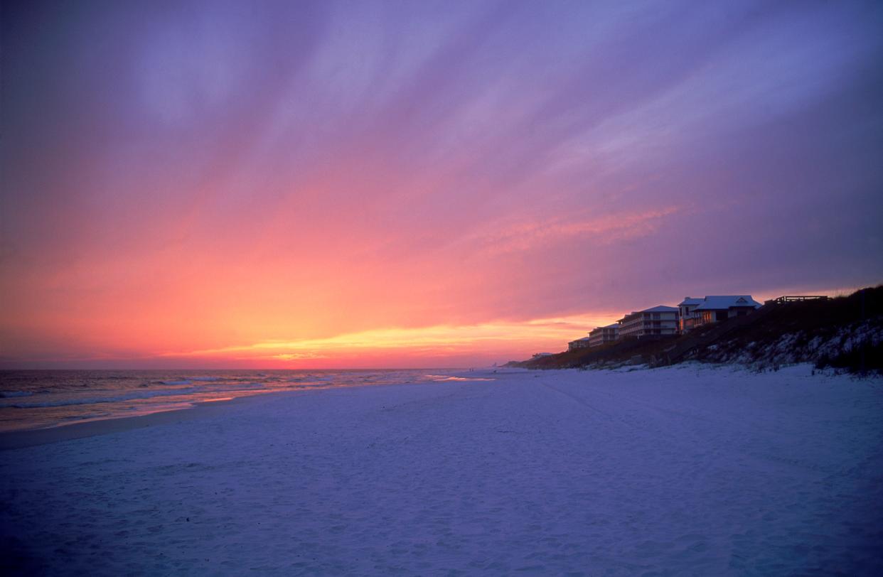 Blue and pink sunset inside a deep purple sky over Rosemary Beach shoreline