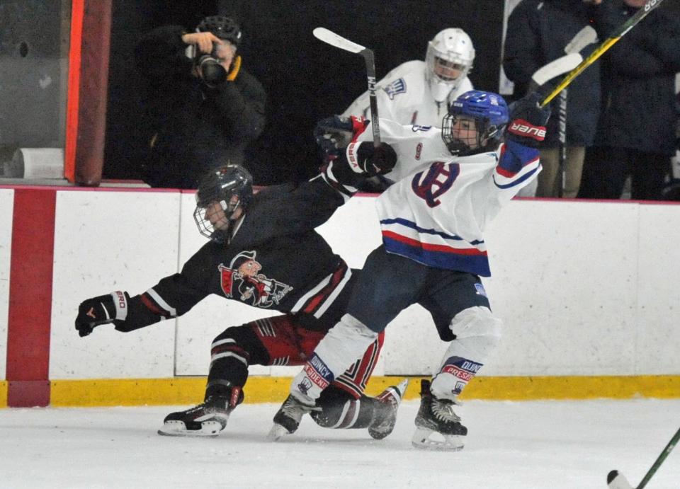 North Quincy's Brian Buckley, left, is checked by Quincy's Cole Quigley, right, during the Holiday Tournament at the Quincy Youth Arena, Tuesday, Dec. 27, 2022.
