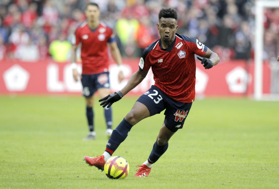 Lille's Thiago Mendes in action, center, controls the ball during the French League One soccer match between Lille and Montpellier at the Lille Metropole stadium, in Villeneuve d'Ascq, northern France, Sunday, Feb. 17, 2019. (AP Photo/Michel Spingler)