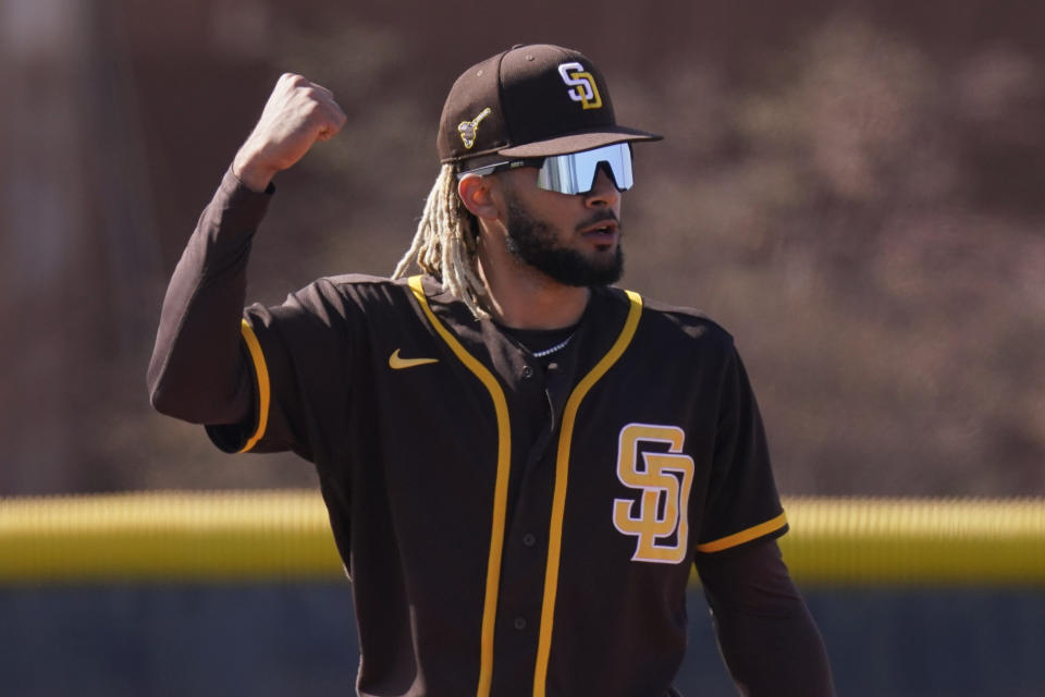 San Diego Padres' Fernando Tatis Jr. reacts after making a catch during spring training baseball practice Saturday, Feb. 27, 2021, in Peoria, Ariz. (AP Photo/Charlie Riedel)