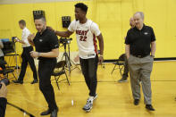 Miami Heat guard Jimmy Butler (22) jokes with Heat staff following an NBA basketball news conference, Friday, Sept. 27, 2019, in Miami. Butler spoke publicly for the first time since the July trade that brought him to South Florida as the new face of the franchise. (AP Photo/Lynne Sladky)