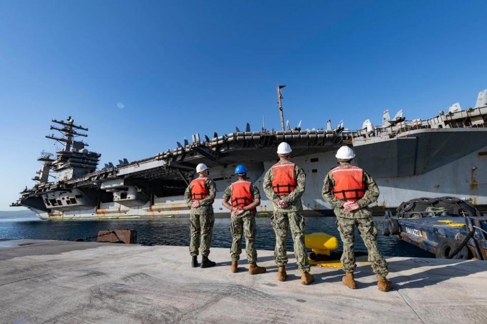 Sailors wait to moor USS Dwight D. Eisenhower at the NATO Marathi Pier Complex in Souda Bay, Greece.