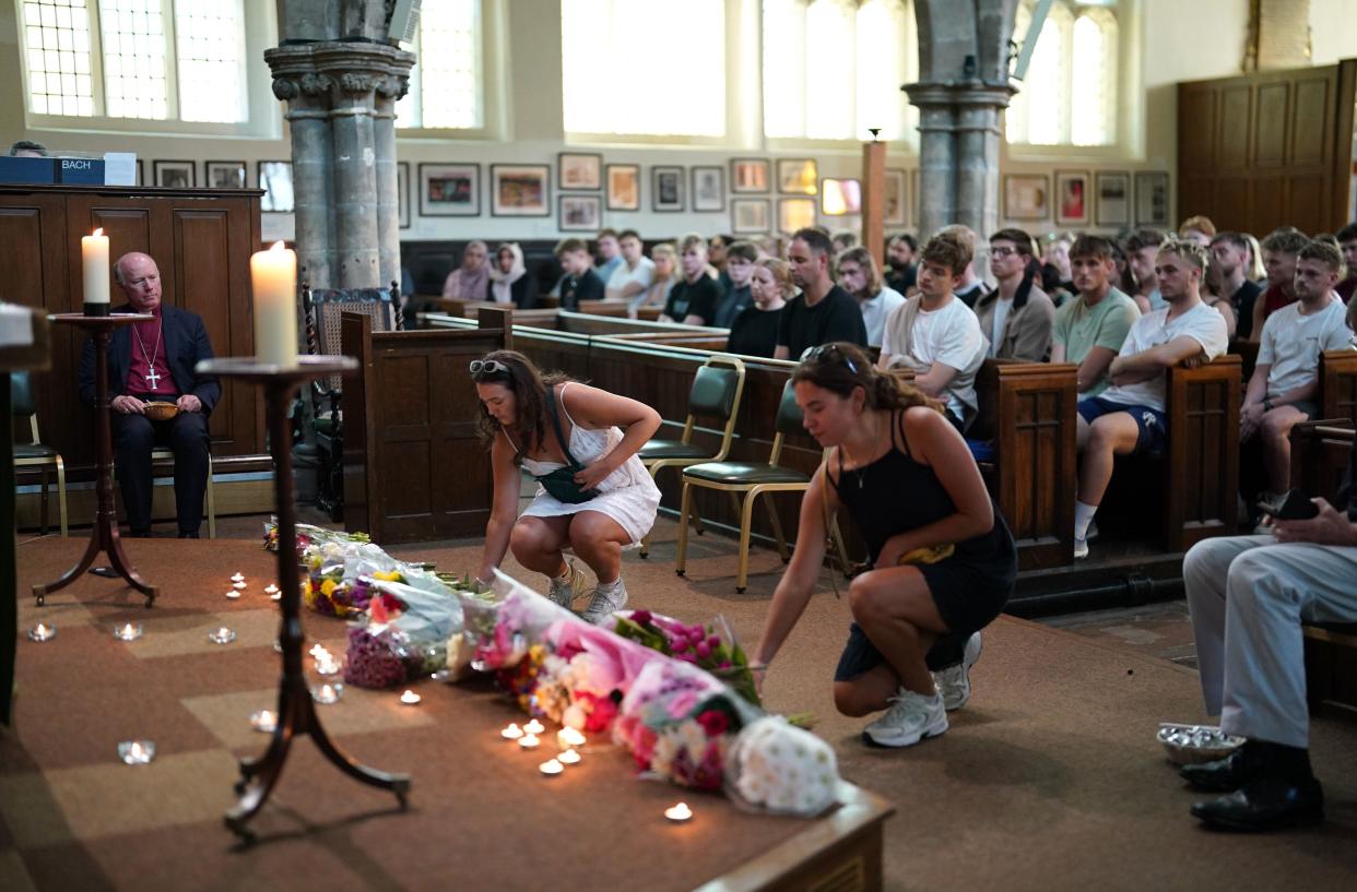 People at a vigil at St Peter's church in Nottingham (PA)