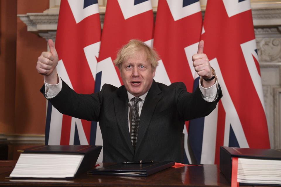 FILE - In this Wednesday, Dec. 30, 2020 file photo, Britain's Prime Minister Boris Johnson gives a thumbs up gesture after signing the EU-UK Trade and Cooperation Agreement at 10 Downing Street, London. It was late on Christmas Eve last year when the European Union and Britain finally clinched a Brexit trade deal after years of wrangling, threats and missed deadlines to seal their divorce. Such was the bile and bad blood stirred up by the diplomatic brinkmanship and bitter divorce that, two months from another Christmas, insults of treachery and duplicitousness are flying again. (Leon Neal/Pool via AP, File)