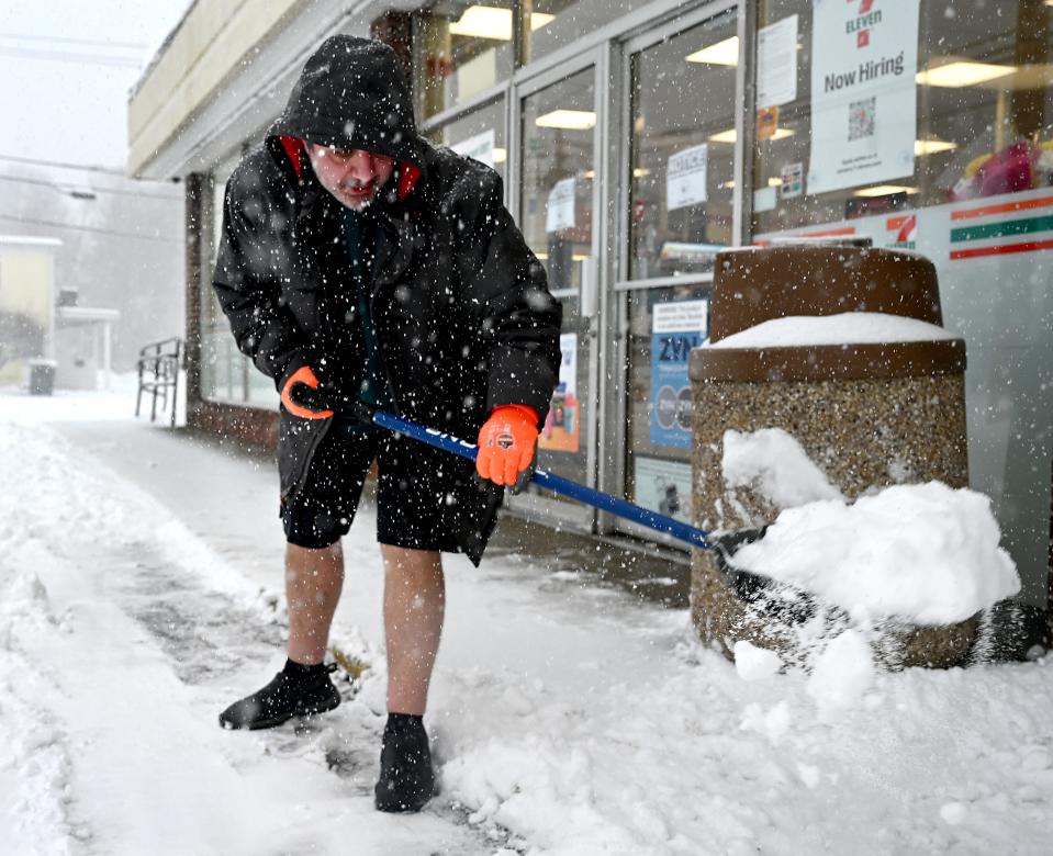 Chris Cataldo shovels in shorts in front of the 7-Eleven on North Main Street (Rte. 27) in Natick, Feb. 25, 2022. Cataldo arrived at work at 5:30 a.m. and had already shoveled four times by 9 a.m.