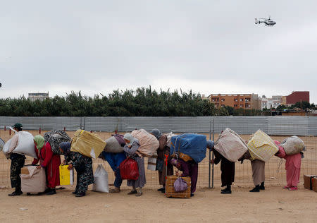 Moroccans queue with goods to be taken across the border from SpainÕs North African enclave of Melilla into Moroccan settlement of Beni Ansar, in Melilla, Spain July 19, 2017. Picture taken July 19, 2017. REUTERS/Youssef Boudlall