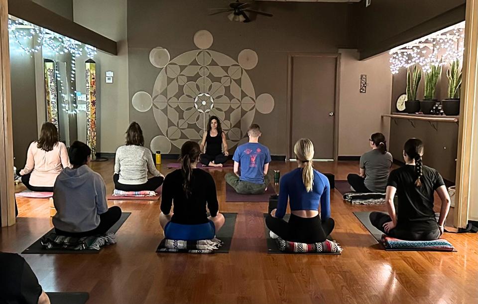 A yoga class led by Christa Christensen takes place recently. Christensen has been named as studio manager for The Breathing Tree.