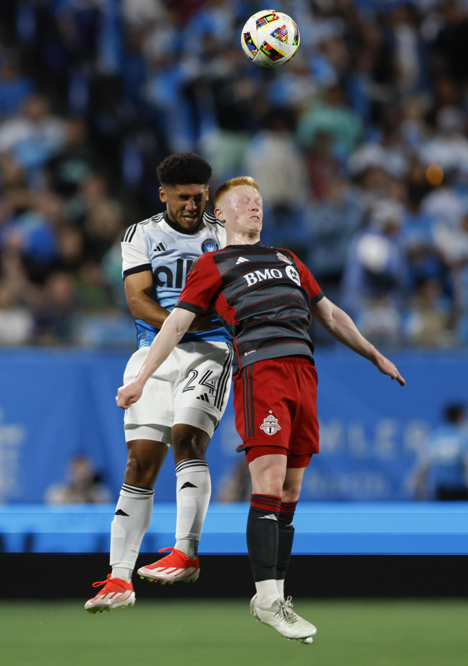 Charlotte FC defender Jaylin Lindsey, left, and Toronto FC midfielder Matty Longstaff jump for a head ball during the first half of an MLS soccer match in Charlotte, N.C., Saturday, April 13, 2024. (AP Photo/Nell Redmond)