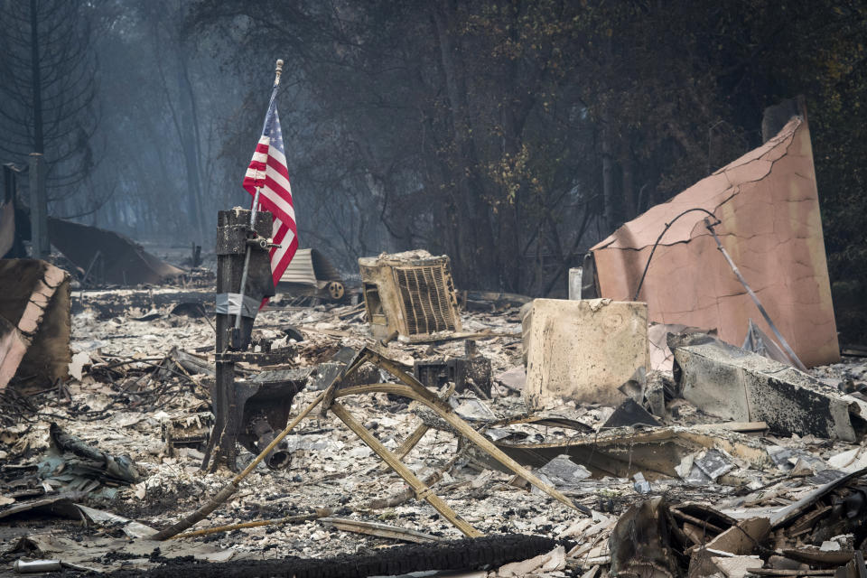 An American flag stands among burned rubble in Paradise, California, on Nov. 13. The Camp fire north of Sacramento has killed at least 42 people, injured three firefighters and destroyed 6,500 homes. (Photo: Bloomberg via Getty Images)