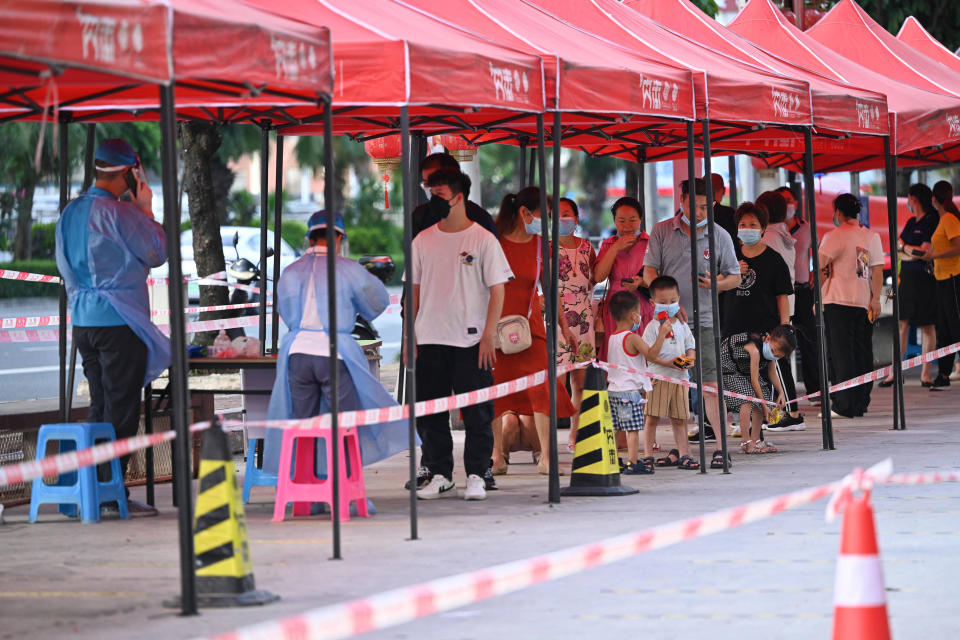 This photo taken on July 19, 2022 shows residents queueing to be tested for the Covid-19 coronavirus at a swab collection site in Nanning in China's southern Guangxi region. - China OUT (Photo by AFP) / China OUT (Photo by STR/AFP via Getty Images)