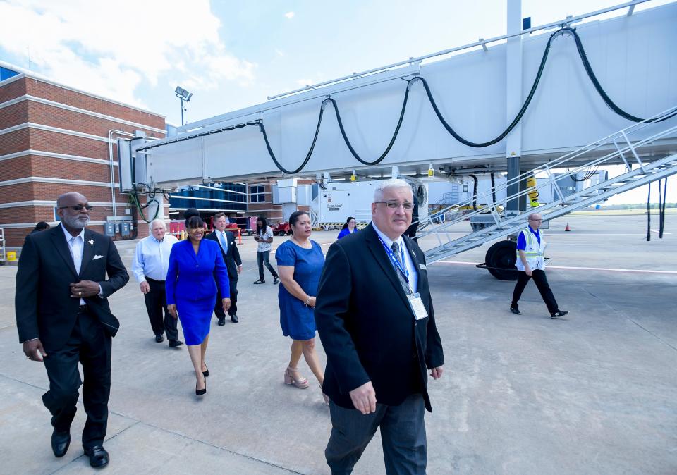 Montgomery Airport Authority Executive Director Wade Davis, foreground, and members of the Airport Board of Directors get a look at the new passenger boarding bridges during the announcement of the improvements and expansion at the Montgomery Regional Airport in Montgomery, Alabama, on Friday, March 24, 2023.