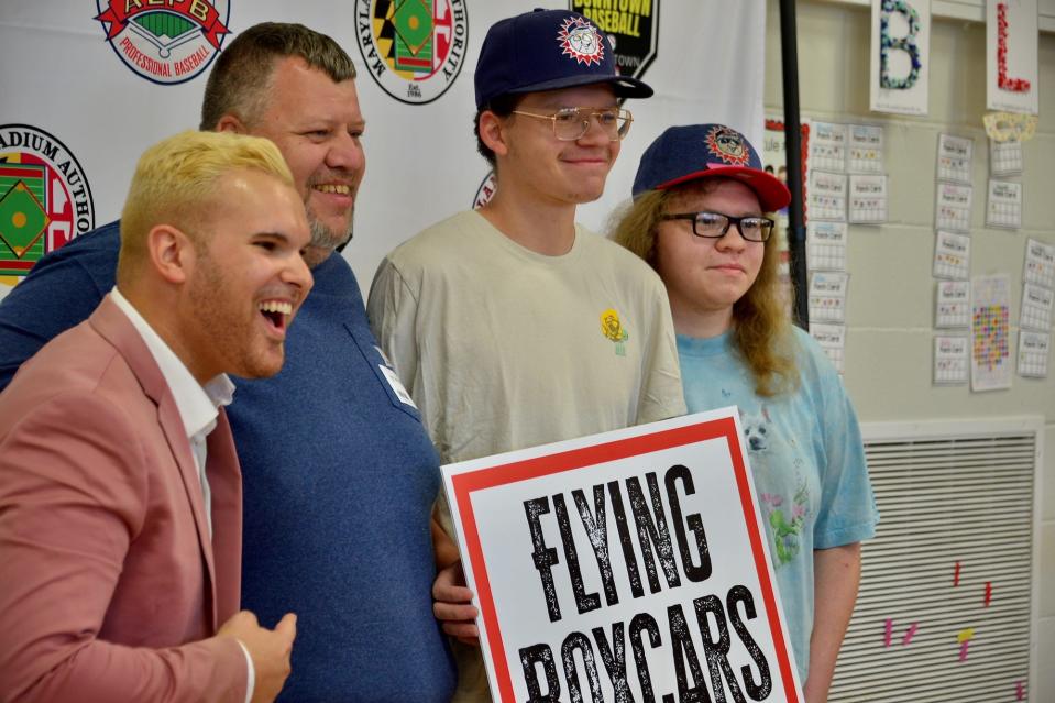 Radio personality Ryan Smetzer, left, Lee Smith and Smith's sons, Arrick and Evan, celebrate the name of a new minor league baseball team for Hagerstown. Sara Smith, Lee's wife, who works in an outpatient behavioral health unit at Meritus Medical Center, was chosen from among those who suggested the name.