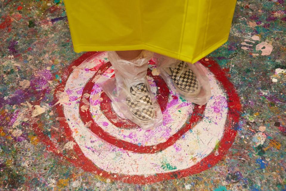 A pair of feet, standing atop a painted target on the floor.