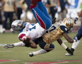 Montreal Alouettes receiver Brandon London, left, is tackled by Winnipeg Blue Bombers Demond Washington during first quarter Canadian Football League pre-season action Thursday, June 14, 2012 in Montreal. THE CANADIAN PRESS/Ryan Remiorz