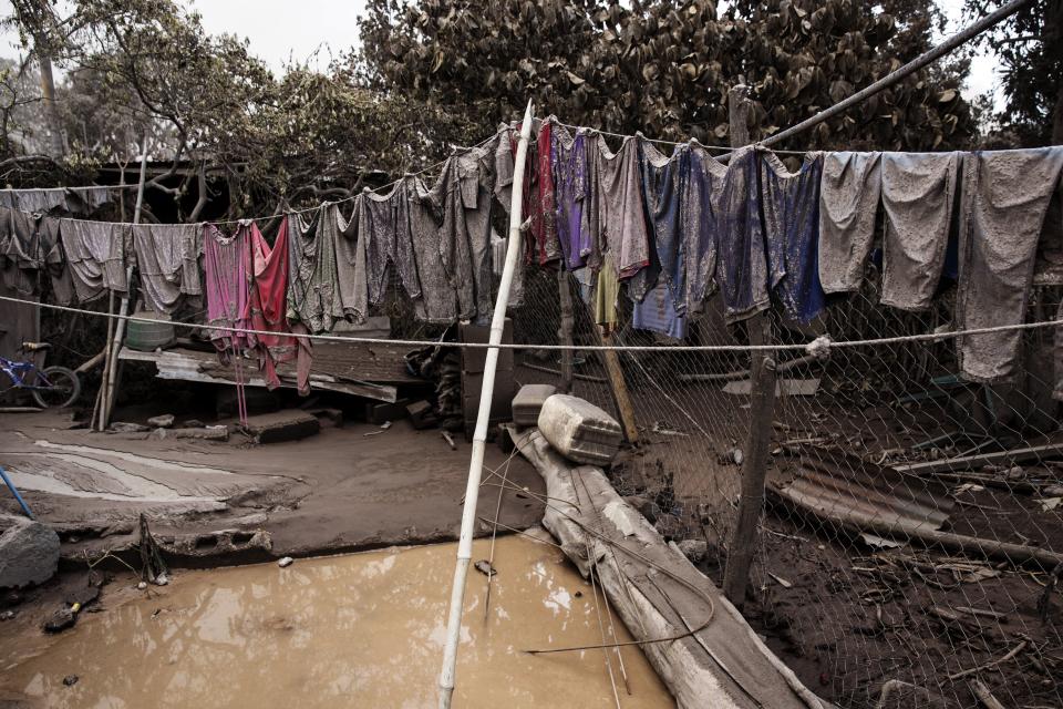 <p>Apparel hung on a clothesline are covered in volcanic ash outside a home in the disaster zone near the Volcan de Fuego, or “Volcano of Fire, in the El Rodeo hamlet of Escuintla, Guatemala, Wednesday, June 6, 2018. (Photo: Rodrigo Abd/AP) </p>