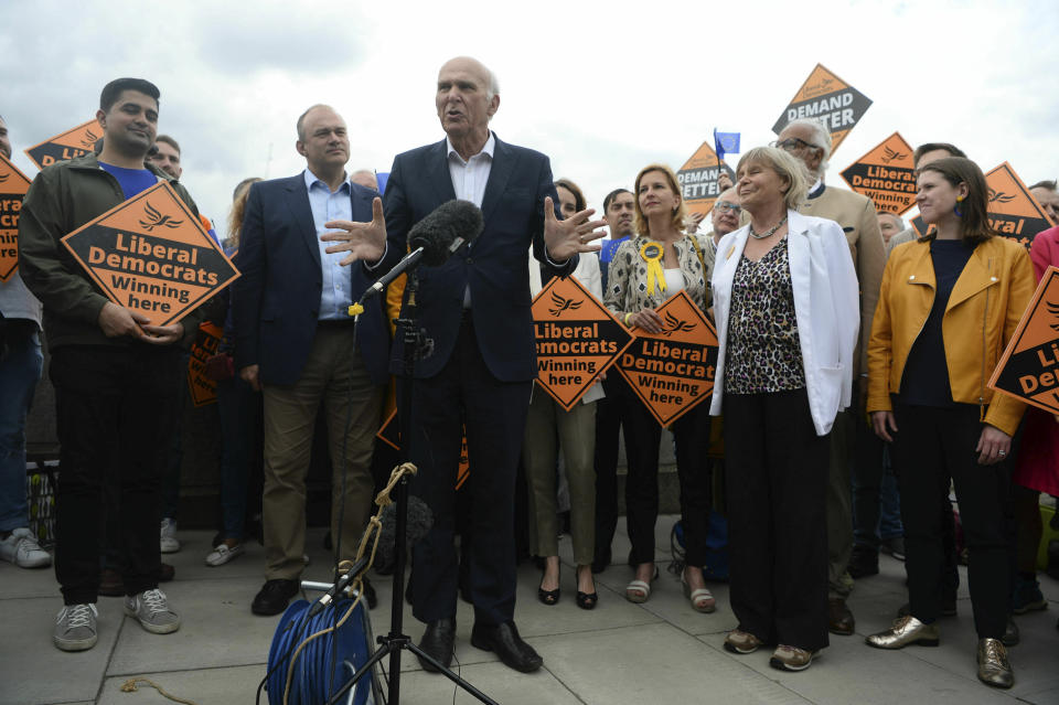 Liberal Democrats leader Sir Vince Cable, center, talks to activists as they celebrate the best ever European Election result in the party's history in central London, Monday, May 27, 2019. With results announced Monday for all regions in the U.K. except Northern Ireland, the Brexit Party had won 29 of the 73 British EU seats up for grabs and almost a third of the votes. On the pro-EU side, the Liberal Democrats took 20% of the vote and 16 seats _ a dramatic increase from the single seat in won in the last EU election in 2014. (Kirsty O'Connor/PA via AP)