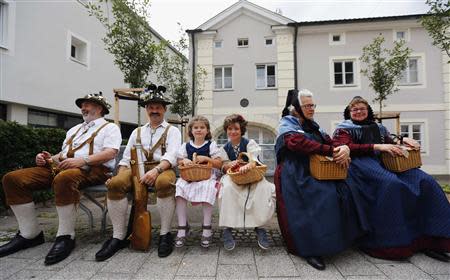 Residents smile during a Sunday Parade in Eichstaett September 8, 2013. REUTERS/Michael Dalder