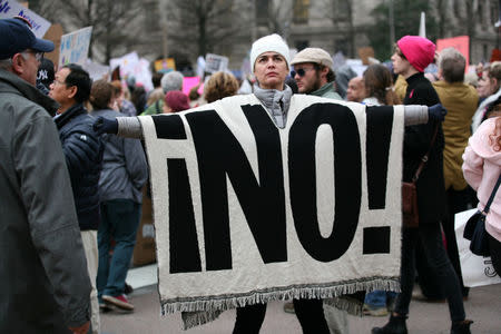 A woman displays a blanket at the Women's March, held in opposition to the agenda and rhetoric of President Donald Trump in Washington, DC, U.S., January 21, 2017. REUTERS/Canice Leung