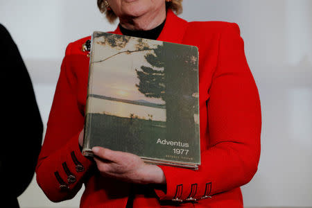 Attorney Gloria Allred holds a yearbook with the maiden name of accuser Beverly Young Nelson, after a statement claiming that Alabama senate candidate Roy Moore sexually harassed her when she was 16, in New York, U.S., November 13, 2017. REUTERS/Lucas Jackson