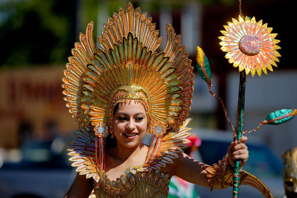 A person with Angels Modeling & Dance Studio walks Oct. 1, 2022, in the the Fiestas de las Americas parade during the annual festival in the Capitol Hill area of Oklahoma City.