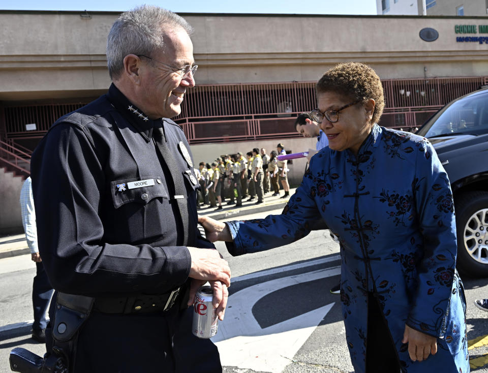 FILE - Los Angeles police chief Michael Moore, left, speaks with Los Angeles Mayor Karen Bass prior to the 124th annual Golden Dragon Parade celebrating the Lunar New Year in Los Angeles on Saturday, Jan. 28, 2023. Moore announced his retirement Friday, Jan. 12, 2024, in an unexpected departure as the head of one of the nation's largest law enforcement agencies. (Keith Birmingham/The Orange County Register via AP)