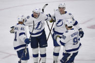 Tampa Bay Lightning right wing Corey Perry, second from left, celebrates after scoring a goal with right wing Pierre-Edouard Bellemare (41), defenseman Cal Foote, second from right, and defenseman Mikhail Sergachev during the first period of an NHL hockey game, Sunday, Nov. 28, 2021, in St. Paul, Minn. (AP Photo/Craig Lassig)