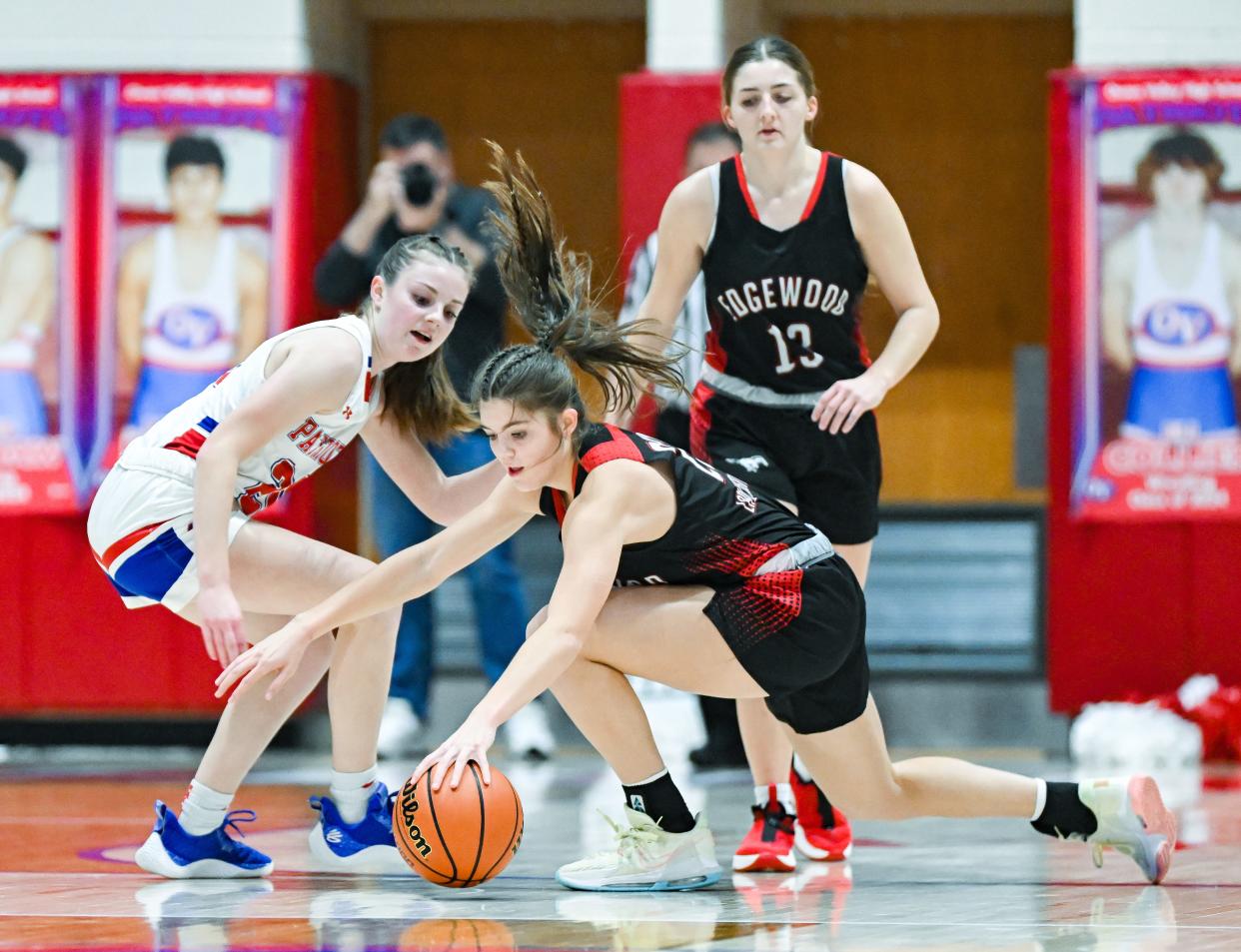 Edgewood’s Macey Crider (22) recovers a loose ball in front of Owen Valley’s Hannah Bixler (20) during their game at Owen Valley on Friday, Jan. 12, 2024.