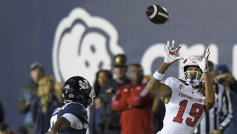 Fresno State wide receiver Josiah Freeman (19) catches a pass as Utah State safety Ike Larsen defends during the second half of an NCAA college football game Friday, Oct. 13, 2023, in Logan, Utah. 