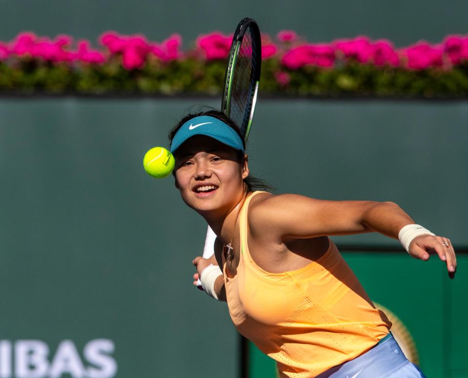 Emma Raducanu of Great Britain hits autographed tennis balls to the crowd after winning her first-round match against Danka Kovinic of Montenegro at the BNP Paribas Open at the Indian Wells Tennis Garden in Indian Wells, Calif., Thursday, March 9, 2023. 