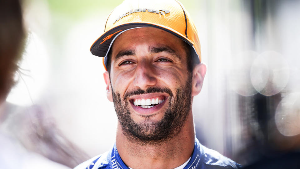 Daniel Ricciardo smiles as he speaks with the press.