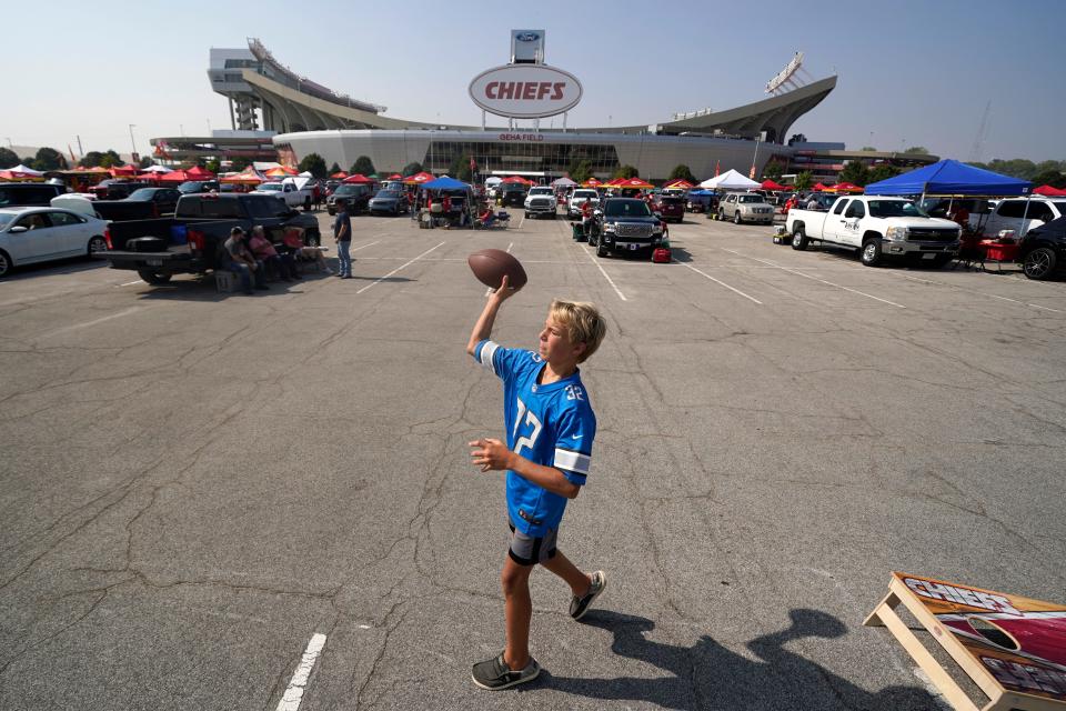 Gavin Sheehan, 12, from Traverse City, Mich., plays catch while tailgating outside Arrowhead Stadium before an NFL football game between the Kansas City Chiefs and the Detroit Lions Thursday, Sept. 7, 2023, in Kansas City, Mo.