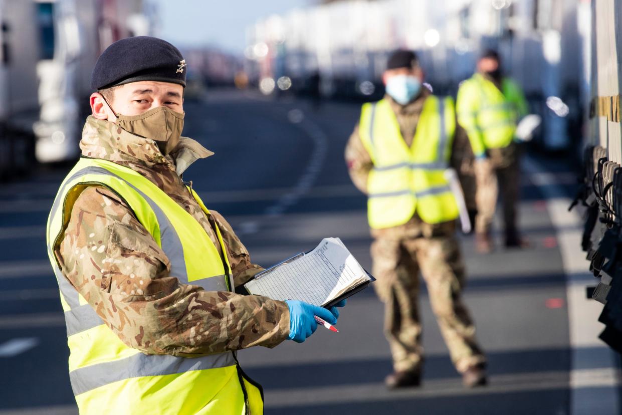 <p>British Army soldiers delivering Covid-19 tests to a lorry drivers on the M20 in Kent</p> (PA)