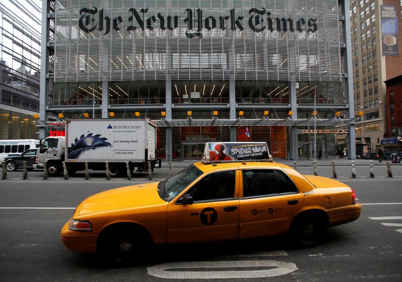 FILE PHOTO: A taxi passes by in front of The New York Times head office in New York