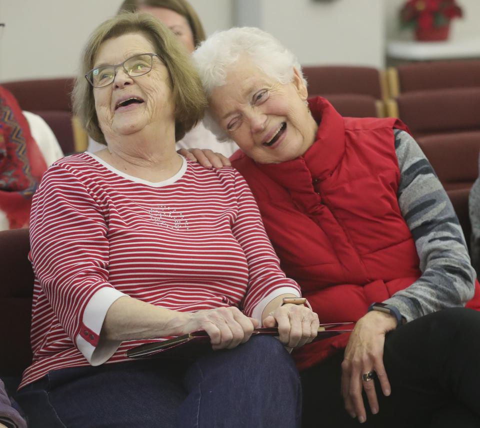 Former Macy's employees Joanna Bennett, left, and Jo Anne Kitchin share a laugh Wednesday during a gathering in Stow City Council chambers to mark the demolition of a retail landmark that served the city for half a century.