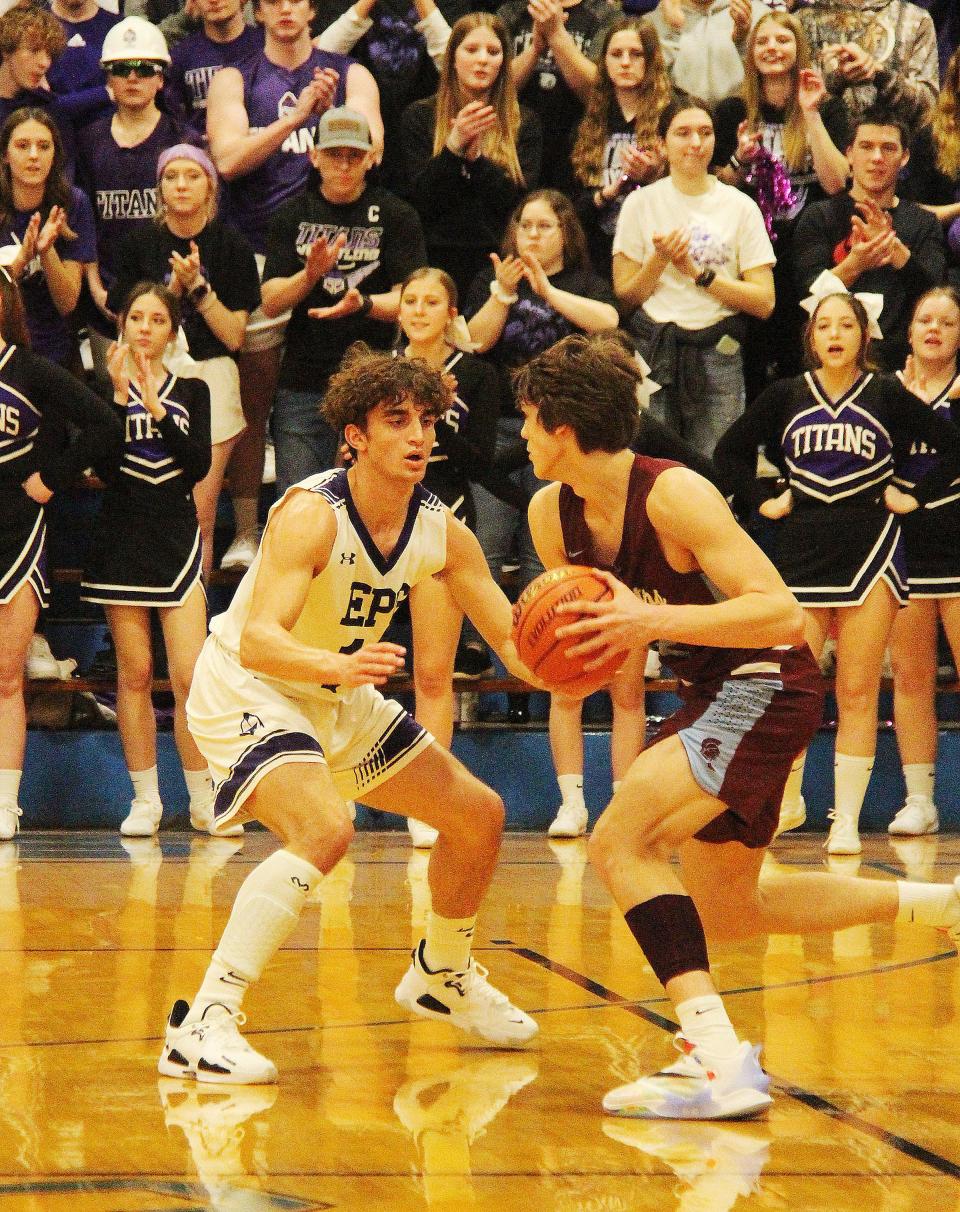 With the El Paso-Gridley faithful cheering in the background, Asa Smith applies pressure to Ty Pence of St. Joseph-Ogden. The high-scoring Pence was held to six points on the night— all from the free throw line.