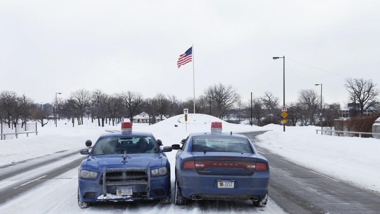 Michigan State Police vehicles sit at the entrance for Belle Isle on Monday February 10, 2014 during the first day the park in Detroit became a state park.