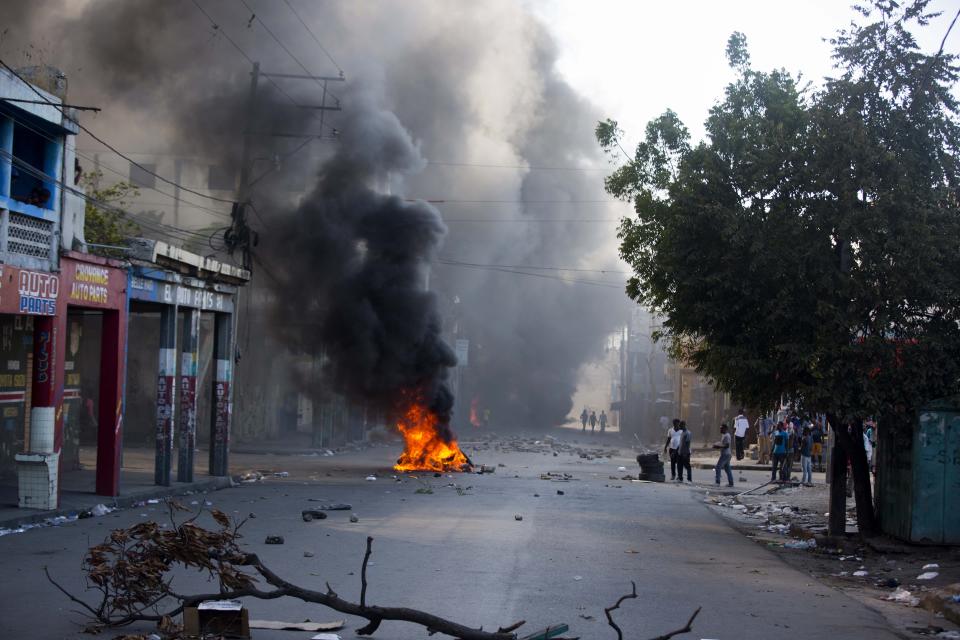 Tires burn in the street during a protest to demand the resignation of President Jovenel Moise and demanding to know how Petro Caribe funds have been used by the current and past administrations, in Port-au-Prince, Haiti, Saturday, Feb. 9, 2019. Much of the financial support to help Haiti rebuild after the 2010 earthquake comes from Venezuela's Petro Caribe fund, a 2005 pact that gives suppliers below-market financing for oil and is under the control of the central government. (AP Photo/Dieu Nalio Chery)