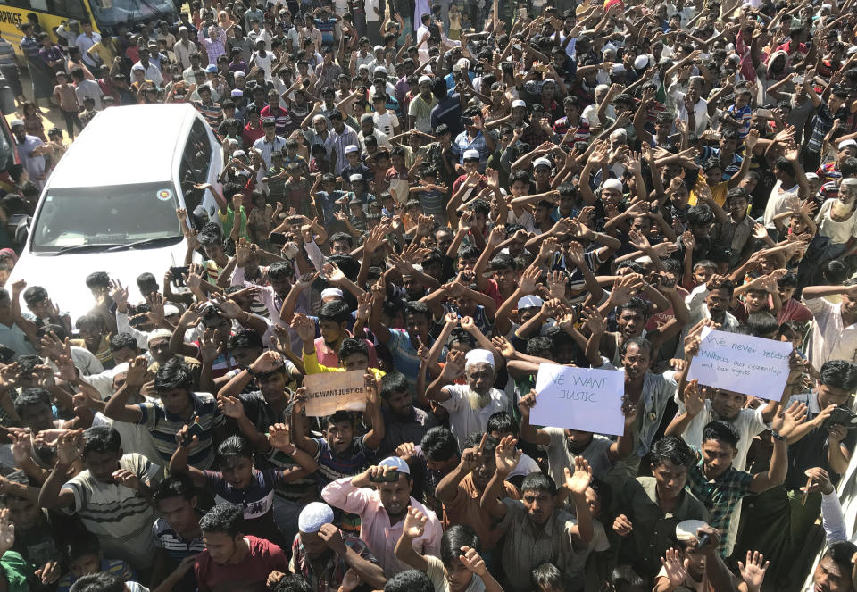 Rohingya refugees shout slogans against repatriation at Unchiprang refugee camp near Cox's Bazar, in Bangladesh, Thursday, Nov. 15, 2018. About 1,000 Rohingya Muslim refugees demonstrated Thursday at a camp in Bangladesh against plans to repatriate them to Myanmar, from where hundreds of thousands fled army-led violence last year.(AP Photo/Dar Yasin)