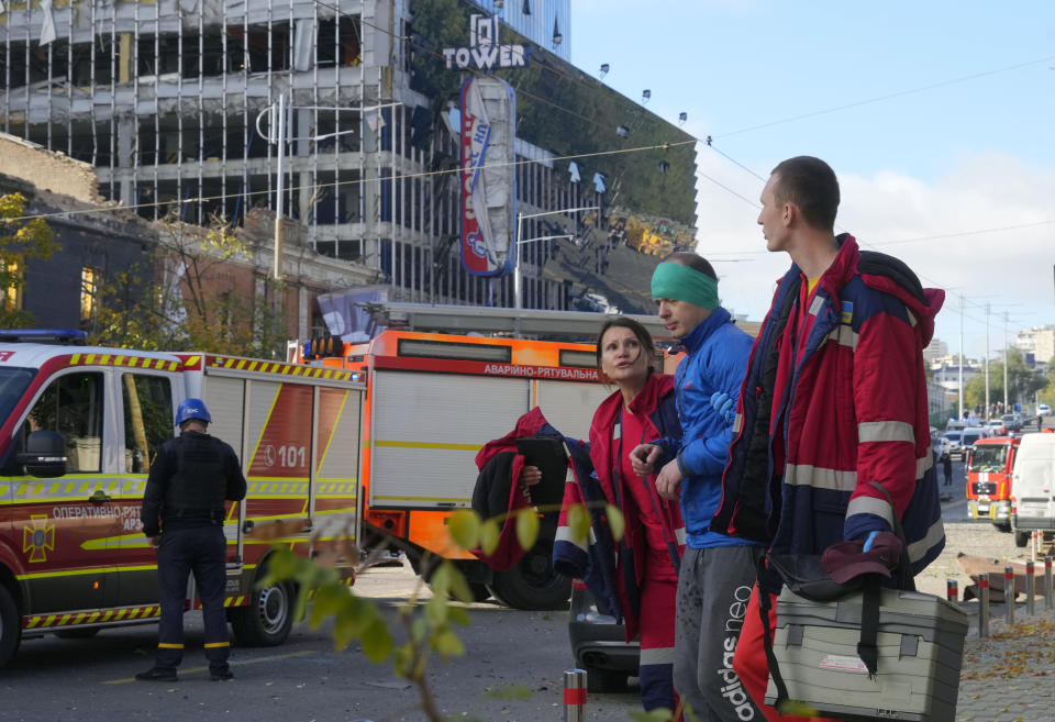 FILE - An injured man receives medical treatment at the scene of Russian shelling, in Kyiv, Ukraine, Monday, Oct. 10, 2022. Ukrainians' resilience in the nearly 8-month-old war continues to be unwavering, despite an uptick in attacks that are seen as Russian President Vladimir Putin's vengeful response to an explosion that damaged a Moscow-built bridge to the Kremlin-annexed Crimean Peninsula on Oct. 8. (AP Photo/Efrem Lukatsky, File)