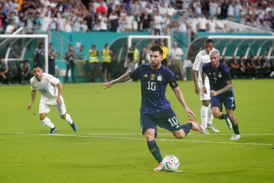 FILE - Argentina forward Lionel Messi kicks a goal, Friday, Sept. 23, 2022, during the first half of an international friendly soccer match against Honduras in Miami Gardens, Fla. Lionel Messi says he is coming to Inter Miami and joining Major League Soccer. After months of speculation, Messi announced his decision Wednesday, June 7, 2023, to join a Miami franchise that has been led by another global soccer icon in David Beckham since its inception but has yet to make any real splashes on the field.(AP Photo/Wilfredo Lee, File)