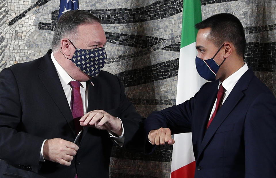 U.S. Secretary of State Mike Pompeo, left, bumps elbows with Italian Foreign Minister Luigi Di Maio in Rome, Wednesday, Sept. 30, 2020. Pompeo is in Italy as part of his six-day trip to Southern Europe. (Guglielmo Mangiapane/Pool Photo via AP)