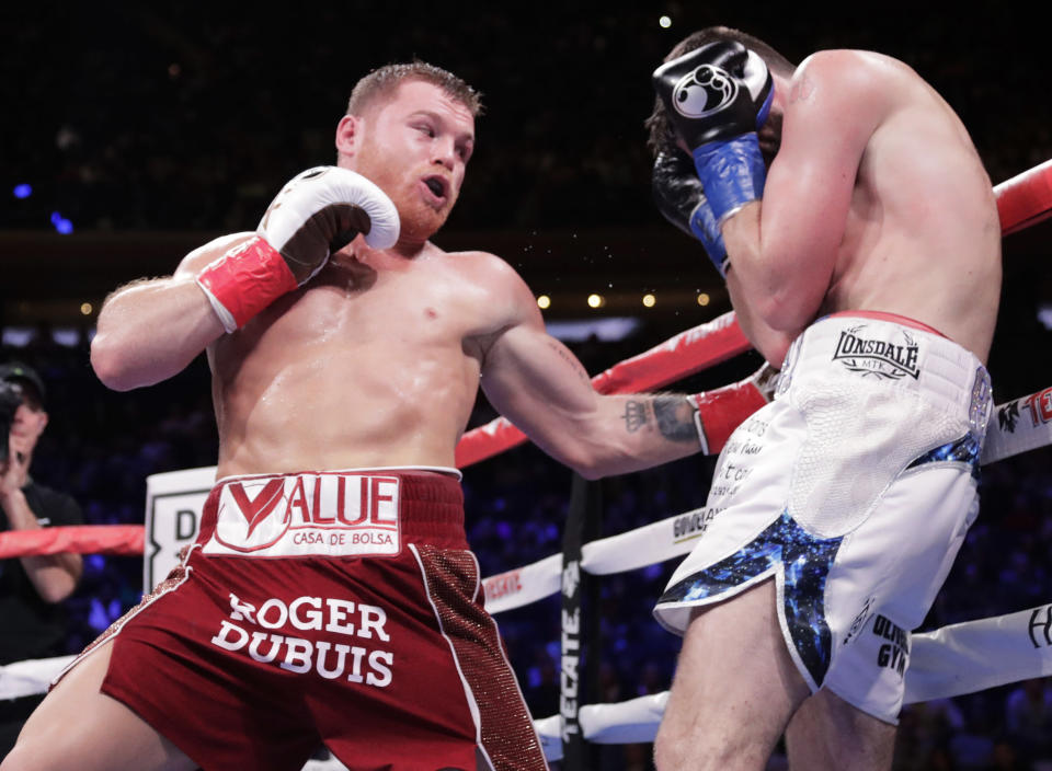 Mexico's Canelo Alvarez, left, punches England's Rocky Fielding during the third round of a WBA super middleweight championship boxing match Saturday, Dec. 15, 2018, in New York. Alvarez stopped Fielding in the third round. (AP Photo/Frank Franklin II)