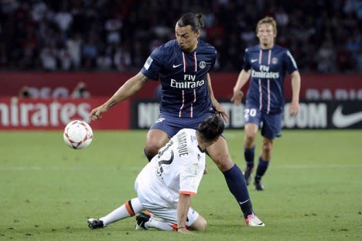 Paris Saint-Germain's forward Zlatan Ibrahimovic (top) fights for the ball with Lorient's defender Lucas Mareque during their French L1 football match at the Parc des Princes stadium in Paris. Paris Saint Germain thanked a double from new signing Zlatan Ibrahimovic on Saturday - including a last-gasp penalty - as they could only draw 2-2 against lowly Lorient in their opening French league match