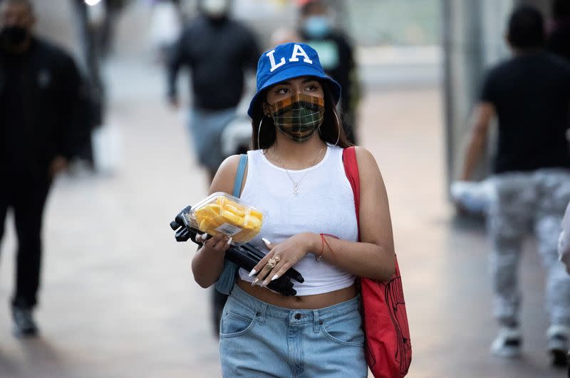 A person wears a personal protective mask while walking downtown during the outbreak of the coronavirus disease (COVID-19), in Los Angeles